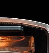 Vue partielle rapprochée de ce qui semble être un contenant en verre ou transparent avec éclairage intérieur cuivré, sur fond noir.