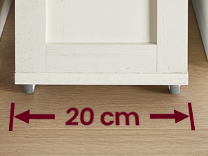Schéma d'espacement des meubles montrant une mesure de 20 cm marquée par des flèches rouges entre un mur et un meuble.