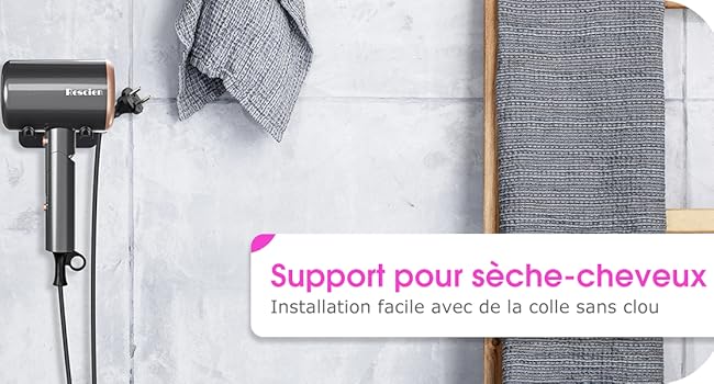 Support mural pour sèche-cheveux noir, fixé à un mur en béton. Des serviettes grises pendent à proximité. Le texte rose en français décrit une installation facile sans clous.