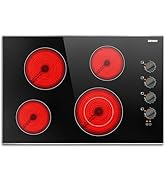 avec quatre éléments chauffants électriques rouges de différentes tailles et boutons de commande sur le côté droit