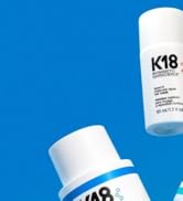 Le texte indique « K18 ». Flacons de produits capillaires professionnels illustrés sur fond bleu vif avec emballage blanc.