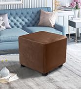 Pouf ou pouf carré en cuir marron avec pieds en bois, représenté dans un salon avec un canapé bleu en arrière-plan