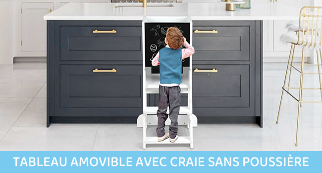 à hauteur d'enfant monté entre des armoires de cuisine grises avec poignées en laiton, permettant aux enfants de dessiner debout sur un marchepied blanc