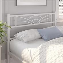 un cadre de lit blanc avec un cadre de lit blanc et une plante dans le coin.