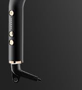 Vue partielle d'un appareil électronique noir avec une charnière ou un mécanisme de pliage visible sur fond sombre.